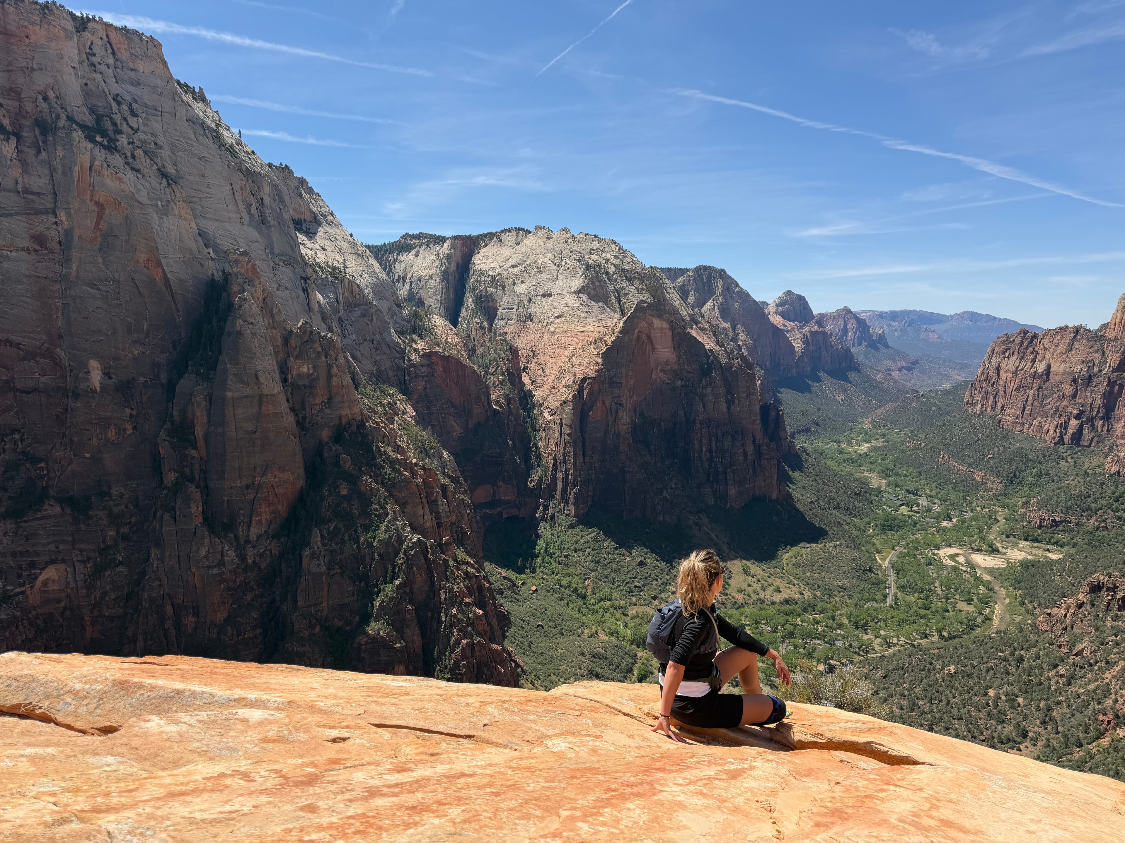 Woman on a trail with arms wide open, feeling free