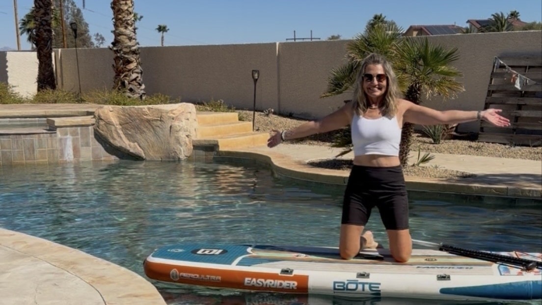 Paddle boarding on calm lake water